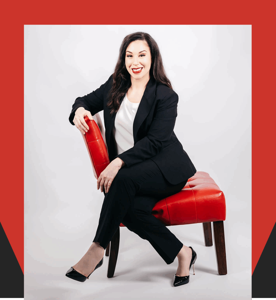 Connecticut Estate Planning Attorney Professional female attorney in black business suit smiling confidently while seated on red chair